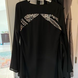 Black Caramela dress with gold detailing on back